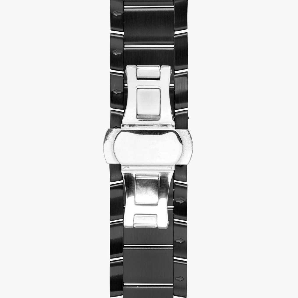 A close-up of a black and silver stainless steel link watch band, showing the clasp mechanism against a light gray background.