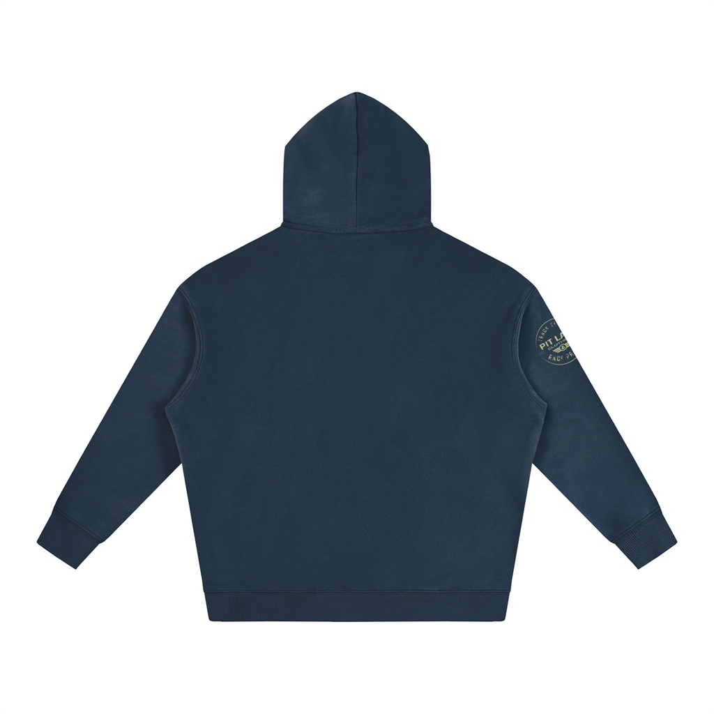 A navy blue hooded sweatshirt shown from the back, featuring a small circular embroidered patch on the left sleeve, set against a plain white background.