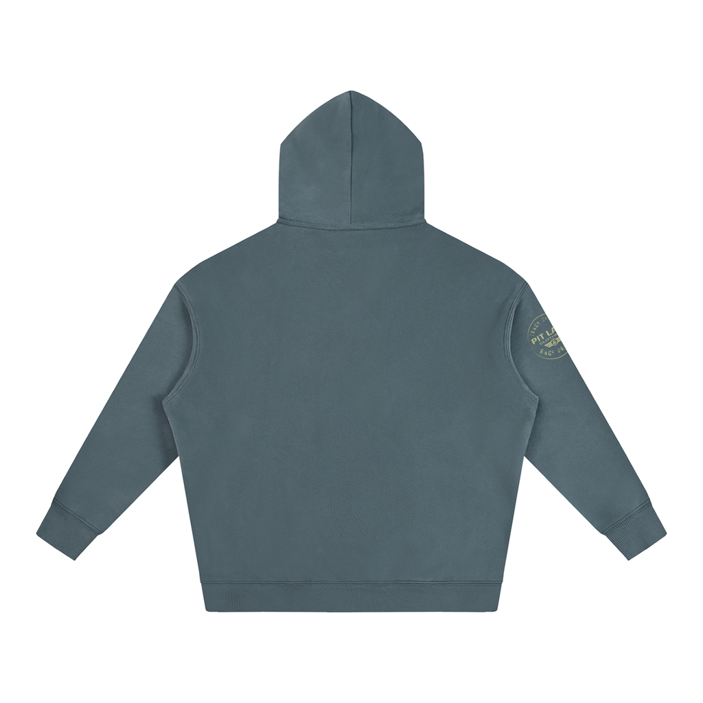 A slate blue-gray hooded sweatshirt shown from the back, featuring a small circular gold graphic on the left sleeve, set against a plain white background.