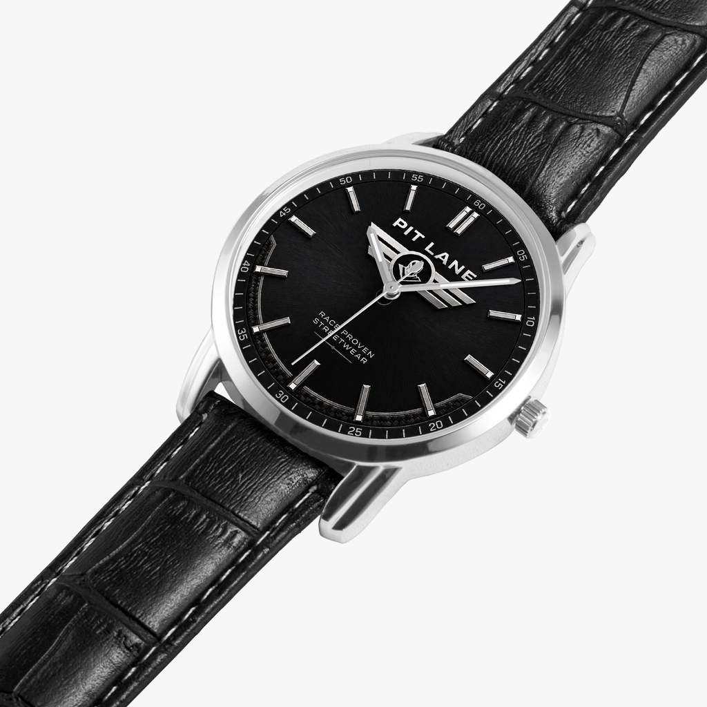 A Pit Lane Clothing wristwatch with a black dial, silver-tone stainless steel case, and a black leather strap, shown against a neutral gray background.