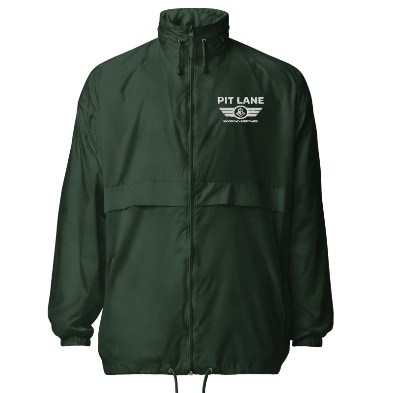 A green lightweight windbreaker jacket with a full front zipper, high collar, and drawstring hem. The left chest features the white printed text 'PIT LANE CLOTHING'.