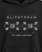 A black pullover hoodie with a white graphic print on the chest featuring the text 'SLIPSTREAM' and 'PIT LANE CLOTHING' with a technical schematic of two cars. The hoodie is displayed on a clean, light gray background.