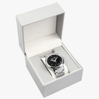 A silver-tone Pit Lane Clothing wristwatch with a black dial and matching silver-tone metal link bracelet, centered against a neutral gray background.