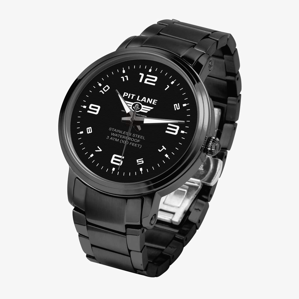 A black Pit Lane Clothing stainless steel watch with a matching black metal link bracelet, featuring a black dial with white Arabic numerals and hands, set against a neutral gray background.