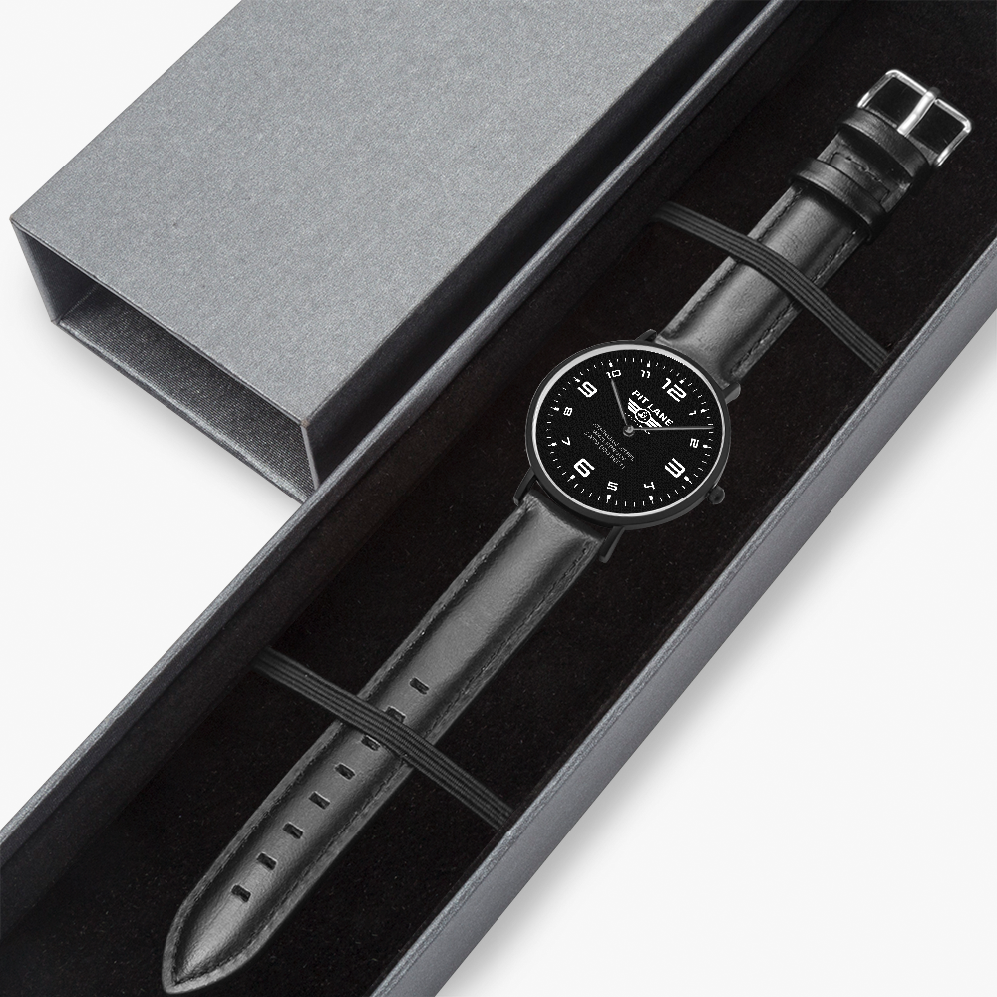 A luxury PIT LANE CLOTHING watch with a black leather strap and a black dial, presented inside a dark gray gift box with its lid placed beside it on a white background.