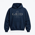 A navy blue pullover hoodie with a front kangaroo pocket and a light gray graphic print on the chest reading 'GRID' with smaller text below, shown on a clean white background.