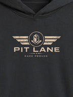 Close-up of a dark charcoal gray hoodie featuring a distressed beige graphic on the chest with the text 'PIT LANE' and 'RACE PROVEN' beneath a winged emblem.