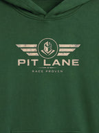 A close-up of a dark green hooded sweatshirt featuring a distressed off-white graphic on the chest with the text 'PIT LANE' and 'RACE PROVEN' beneath it.