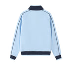 A close-up of a light blue zip-up jacket with a dark navy ribbed collar and a black 'PIT LANE CLOTHING' logo printed on the chest.