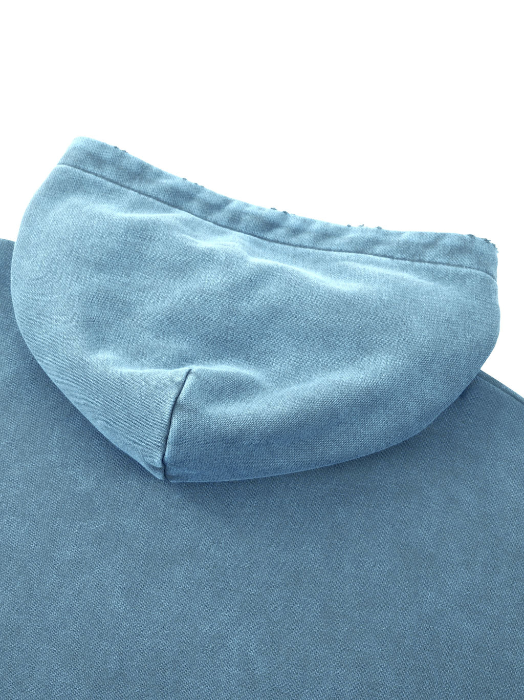 Close-up of a light blue hooded sweatshirt showing the fabric texture of the hood and upper chest area against a white background.
