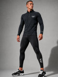 A man modeling a dark gray long-sleeve quarter-zip athletic top and matching black leggings with white PIT LANE CLOTHING logo details, standing against a gray studio background.