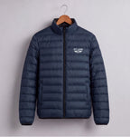 A navy blue puffer jacket with a black front zipper and a white 'PIT LANE' logo on the left chest, hanging on a wooden hanger against a light gray background.