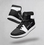 A pair of black and white PIT LANE CLOTHING high-top sneakers floating against a textured gray background. The sneakers feature a black leather upper with white panels, black laces, and a white midsole.