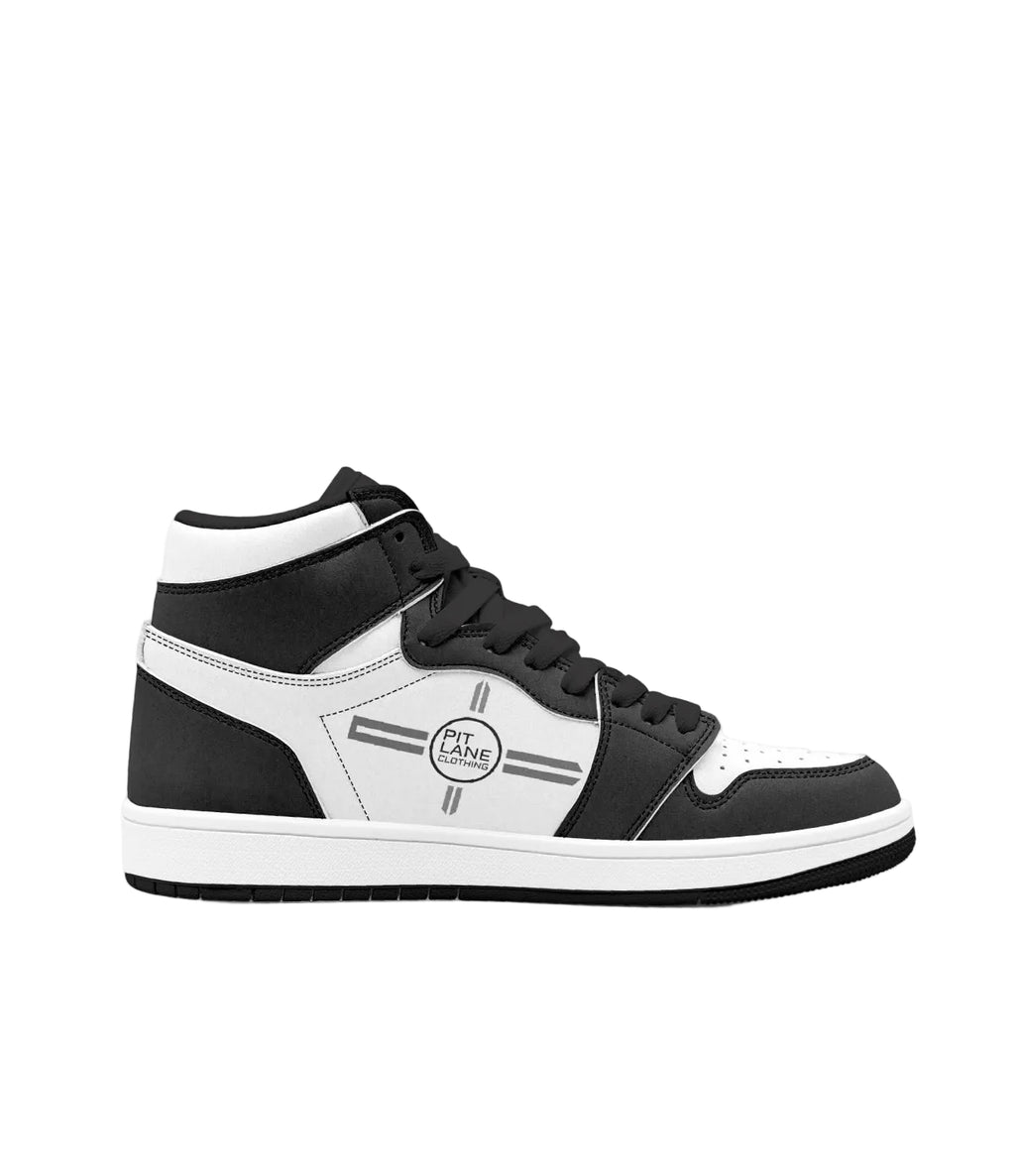 A black and white high-top sneaker with a circular 'PIT LANE CLOTHING' logo on the side, shown in profile against a plain white background.