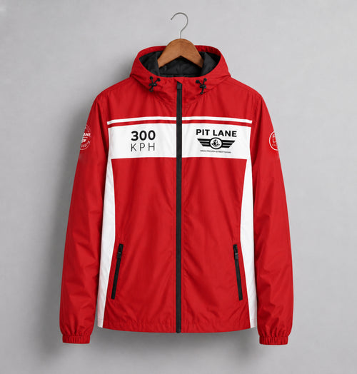 A red hooded jacket with white side panels and a black zipper, hanging on a wooden hanger against a gray background. The chest features a white stripe with '300 KPH' and 'PIT LANE  CLOTHING' branding.