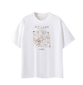 A white short-sleeve crewneck t-shirt featuring a brown graphic print on the front with the text 'PIT LANE CLOTHING' and 'APEX' surrounding a circular technical-style illustration.