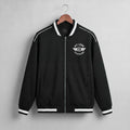 A navy blue zip-up jacket with white contrast stitching, ribbed collar, cuffs, and hem, hanging on a wooden hanger against a light gray textured wall. The left chest features a white circular logo reading 'KIT LANE CLOTHING' with a winged emblem.