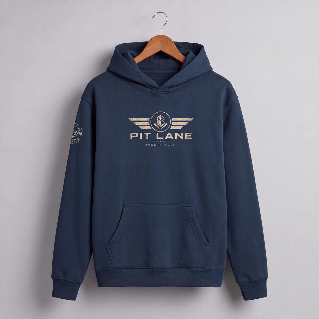 A navy blue pullover hoodie hanging on a wooden hanger against a light gray wall. The hoodie features a gold-toned 'PIT LANE' winged logo on the chest and a small circular logo on the right sleeve.