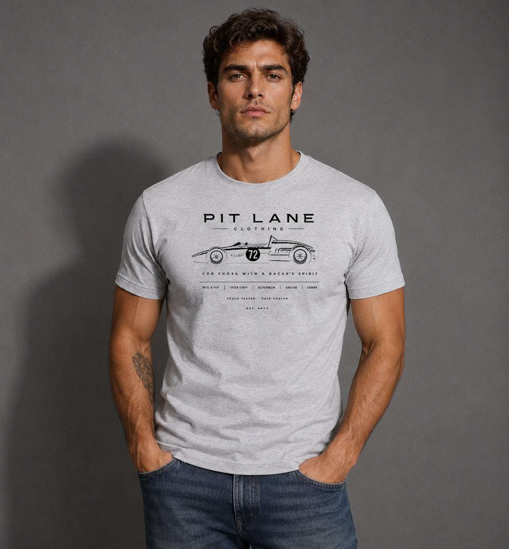 A man wearing a light gray heathered t-shirt with a black graphic print of a vintage race car and the text 'PIT LANE CLOTHING'.