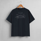A dark navy blue crewneck t-shirt hanging on a wooden hanger against a light gray wall. The shirt features a white line-art graphic of a sports car with technical blueprint annotations and the text 'PIT LANE CLOTHING' printed on the chest.