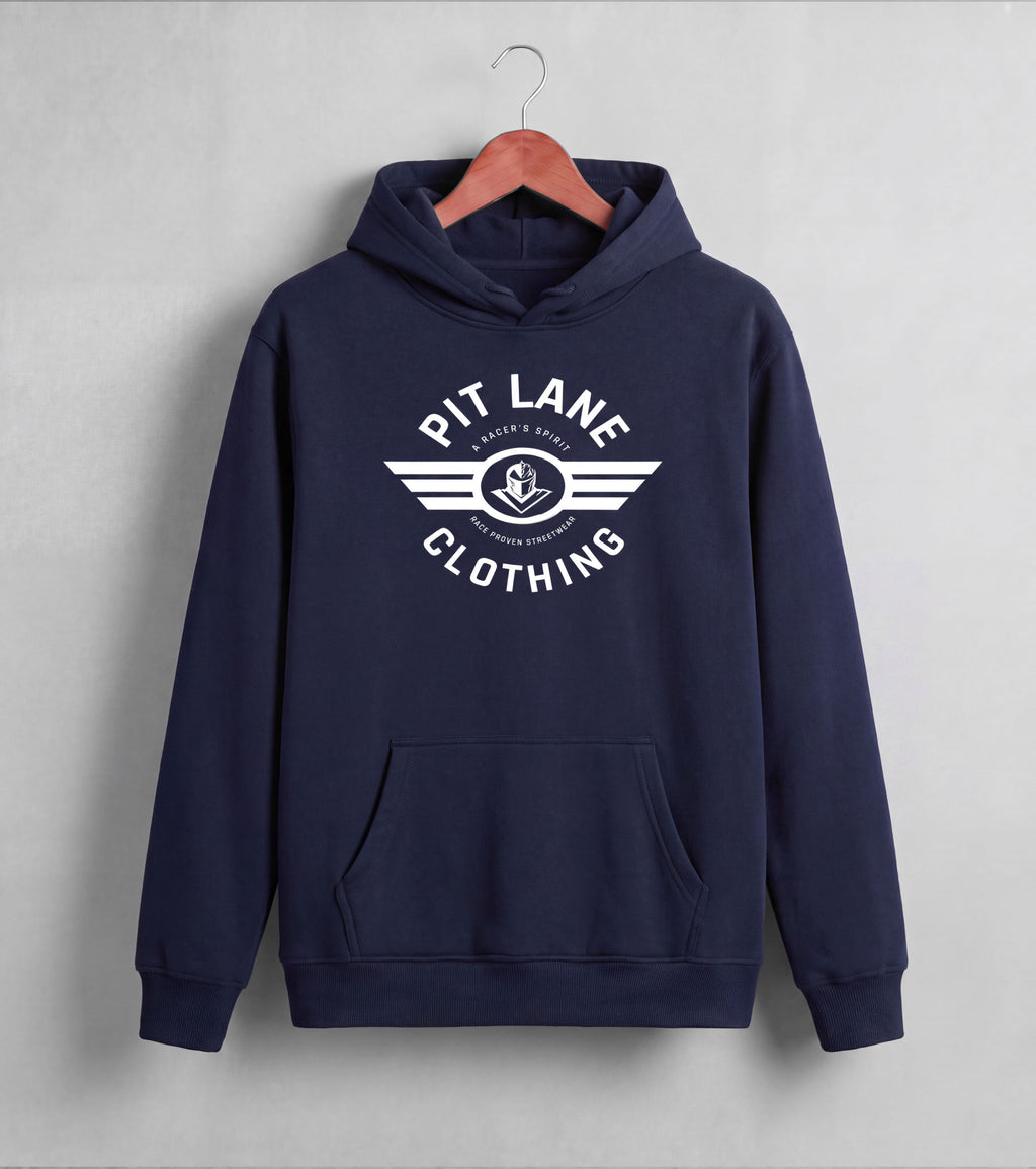 A navy blue pullover hoodie hanging on a wooden hanger against a light gray wall. The hoodie features a white graphic print on the chest that reads 'PIT LANE CLOTHING' with a winged anchor logo in the center.