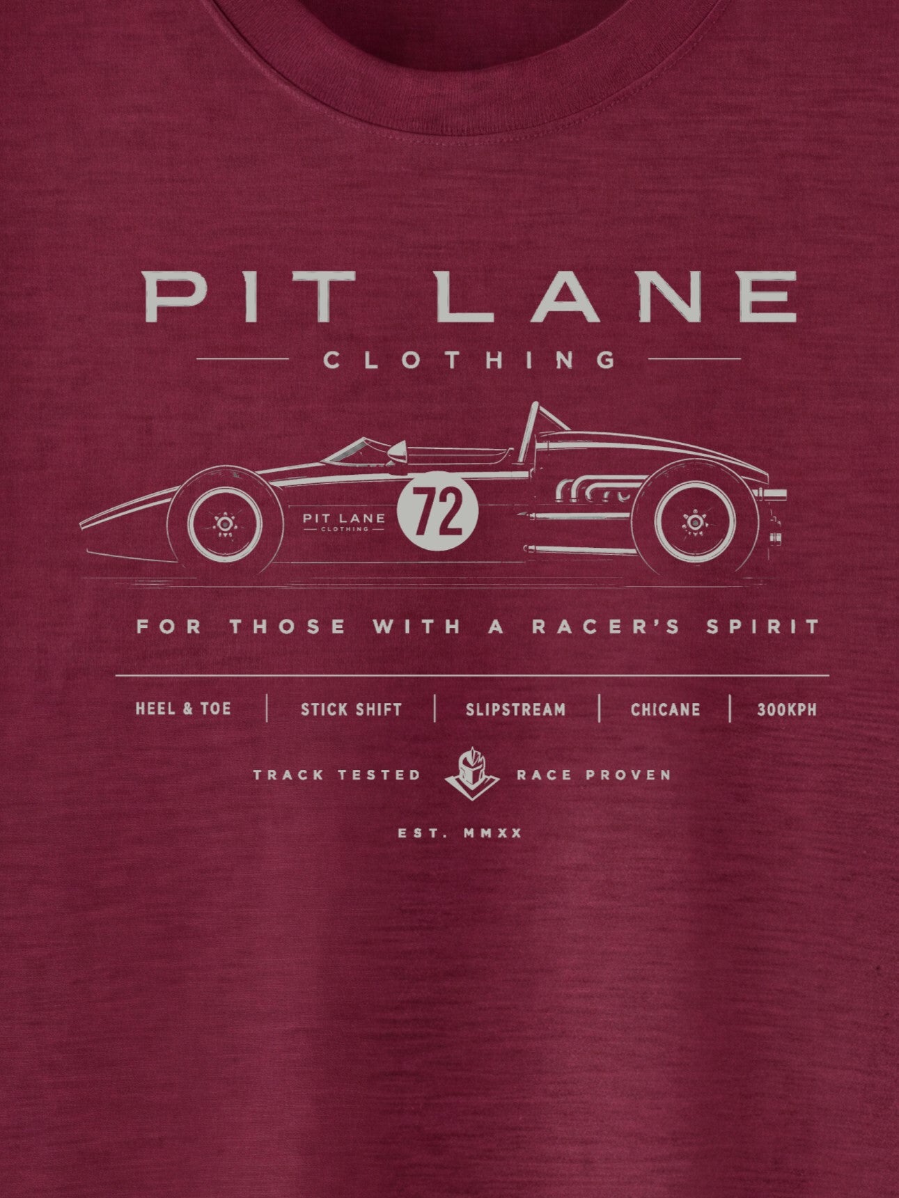 A close-up of a heathered maroon crewneck t-shirt featuring a white graphic print of a vintage race car and 'PIT LANE CLOTHING' text on the chest.