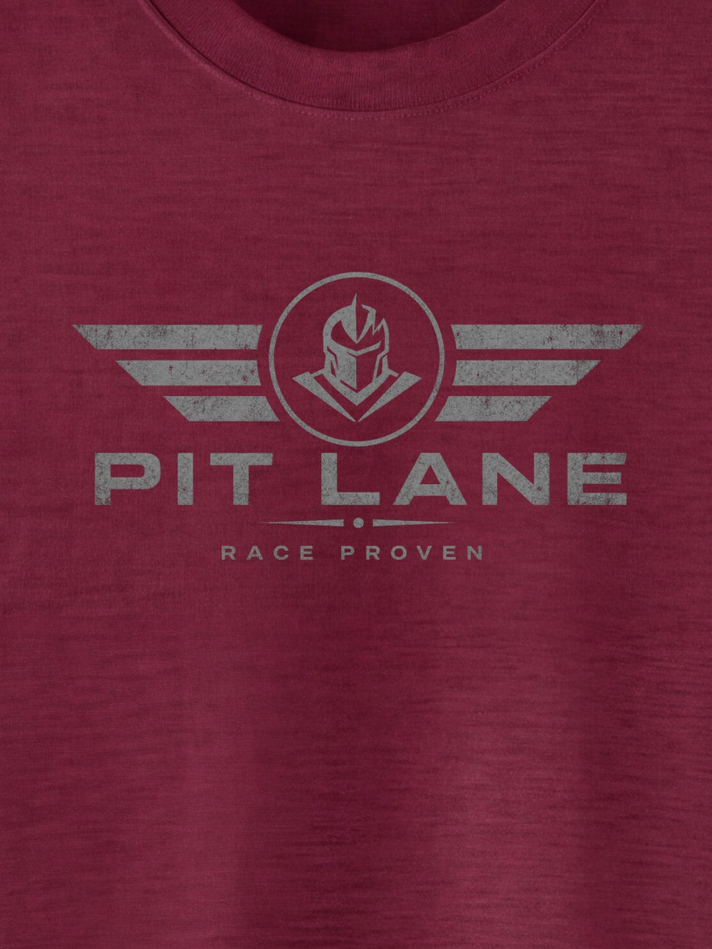 A close-up of a heathered maroon crewneck t-shirt featuring a distressed gray graphic on the chest with the text 'PIT LANE' and 'RACE PROVEN' beneath a winged helmet emblem.