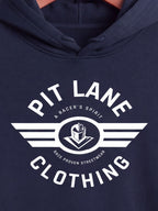 Close-up of a navy blue hoodie featuring a large white graphic print on the chest that reads 'PIT LANE CLOTHING' with a central emblem and wing-like stripes.