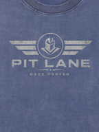 Close-up of a heathered blue crewneck t-shirt featuring a distressed white graphic print of a helmeted knight inside a circle with wings, and the text 'PIT LANE' and 'RACE PROVEN'.